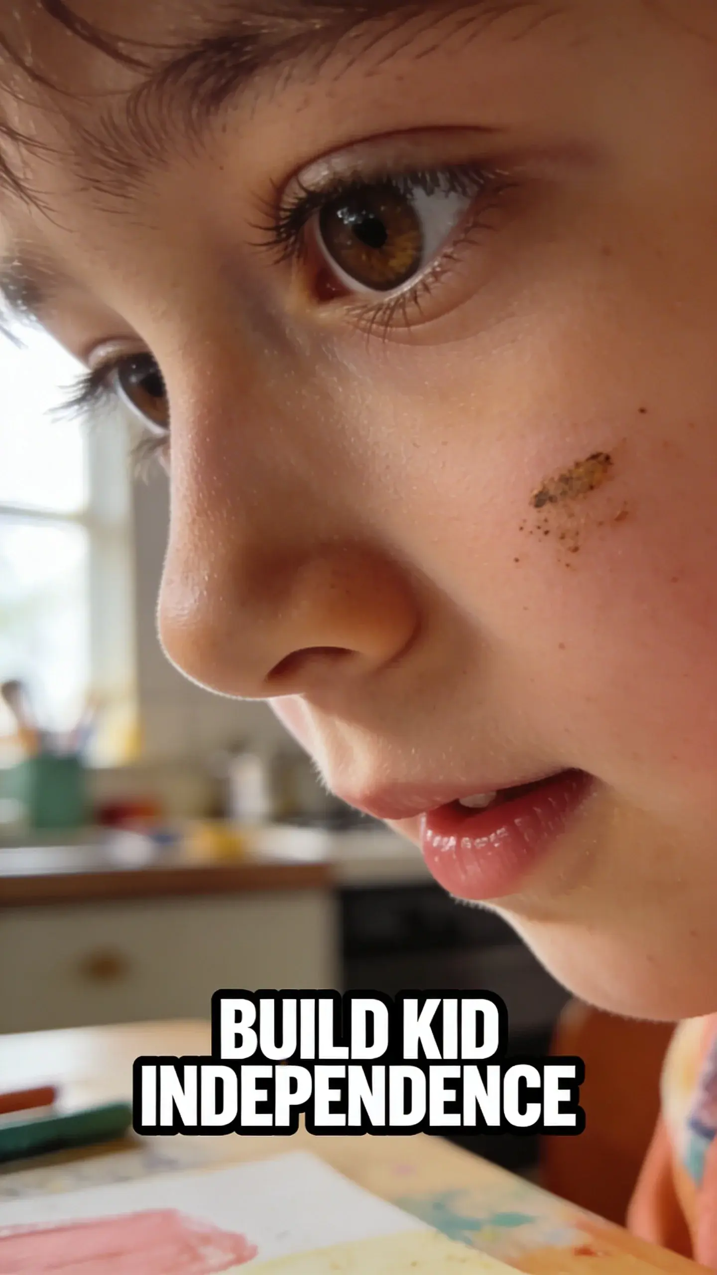 CLOSE-UP FACE EMOTION: extreme close-up of one face (parent or child), vertical 9:16, ultra-tall composition optimized for mobile Pinterest feed, SCENE: An extreme close-up of an elementary-aged child's face, eyes wide with a mix of intense concentration and genuine pride. A slight smudge of paint or dirt is visible on their cheek, hinting at recent activity. They are looking down at something just out of frame, perhaps a completed task on a visual routine chart or a newly finished drawing. The background is softly blurred, suggesting a creative or learning space, like a kitchen table or a child's desk. EMOTION HOOK: Child's newfound independence, TOPIC PHRASE: Build kid independence, TEXT POSITION: BOTTOM-CENTER, OVERLAY: text says exactly: "BUILD KID INDEPENDENCE", bold sans-serif font, high contrast white text with dark outline or shadow so it is readable on mobile, LIGHT: Soft, natural light from a nearby window, illuminating the child's face gently, MOOD: Proud, focused, empowered, joyful, capable, COLOR: muted warm palette (dusty rose, cream, terracotta, soft sage, warm beige), gentle film grain, no logos, no watermarks, photorealistic, 8K, shallow depth of field, film aesthetic, cinematic color grade, no logos, no watermarks
