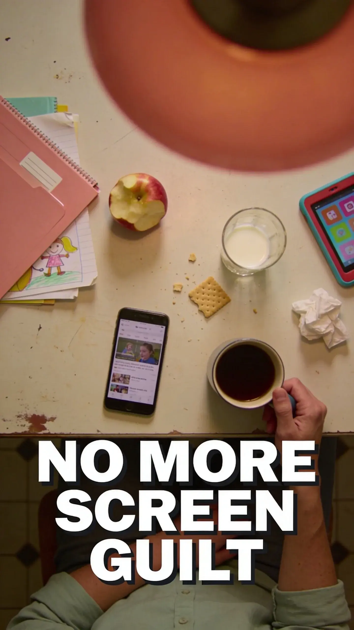**FLAT LAY OVERHEAD**: FLAT LAY OVERHEAD, BASE: vertical 9:16, ultra-tall composition optimized for mobile Pinterest feed, SCENE: An overhead view of a well-worn kitchen table just after school. A half-eaten apple sits next to a discarded school folder with a child's drawing peeking out. A parent's smartphone lies face-up displaying social media, while a small, colorful tablet is pushed slightly to the side. Crumbs from a cracker are scattered near a half-empty glass of milk. A crumpled tissue and a parent's hand, looking weary, resting near a coffee mug complete the picture, conveying the daily grind and the ease with which screens become the default. The overall feeling is one of quiet overwhelm and resignation. EMOTION HOOK: parental guilt about screen time, TOPIC PHRASE: reduce screen time guilt, TEXT POSITION: BOTTOM, OVERLAY: text says exactly: "NO MORE SCREEN GUILT", bold sans-serif font, high contrast white text with dark outline or shadow so it is readable on mobile, LIGHT: soft, diffused kitchen overhead light at 4pm, MOOD: weary, guilty, overwhelmed, reflective, COLOR: muted warm palette (dusty rose, cream, terracotta, soft sage, warm beige), gentle film grain, no logos, no watermarks, QUALITY: photorealistic, 8K, shallow depth of field, film aesthetic, cinematic color grade, no logos, no watermarks